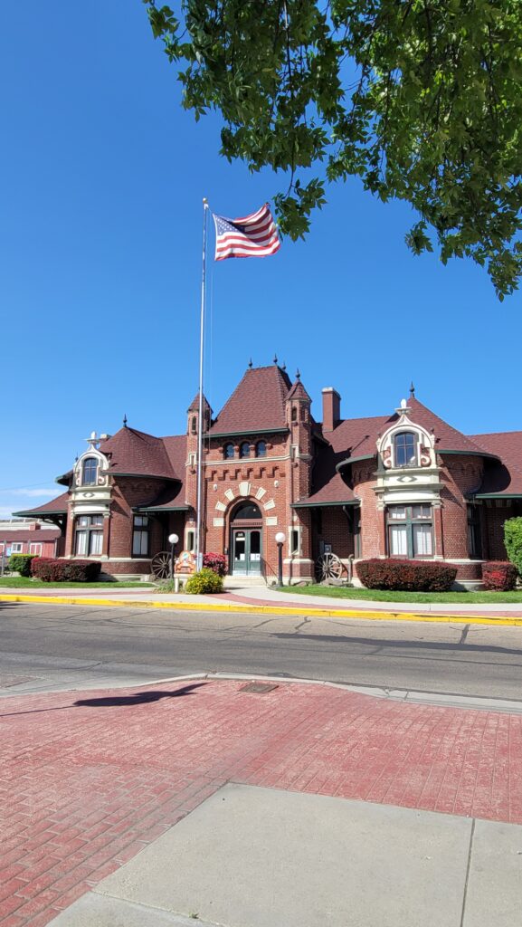 Historic red-brick Nampa Train Depot with arched windows and vintage charm, now home to the Canyon County Historical Museum.
