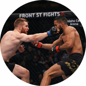 MMA fighters exchanging punches inside the cage at Front Street Fights in Idaho Center Arena