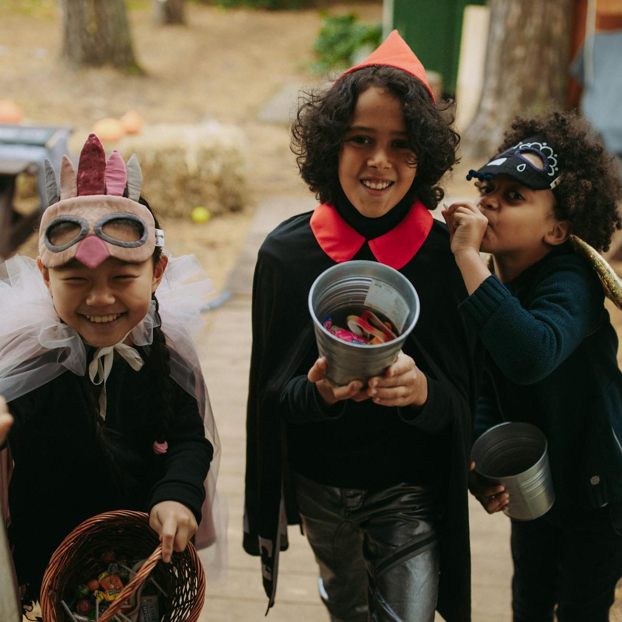Children in Halloween costumes trick-or-treating and holding candy buckets in Nampa, Idaho