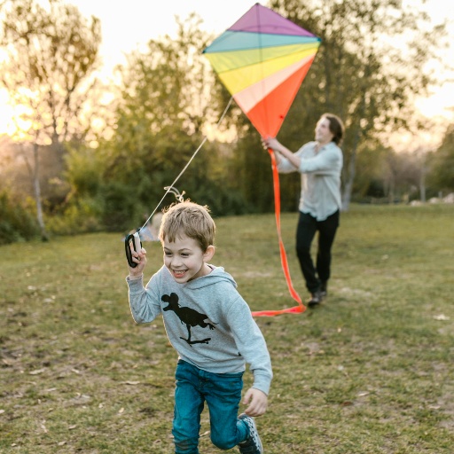 Child running while flying a kite at a park in Nampa, Idaho, enjoying outdoor recreation