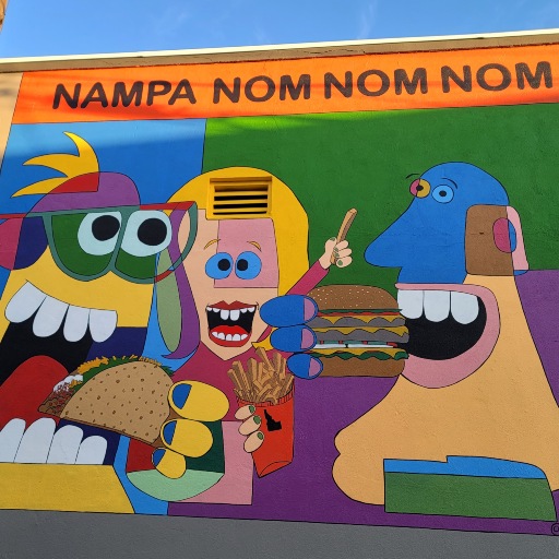 Colorful mural in downtown Nampa, Idaho featuring playful characters and food-themed artwork