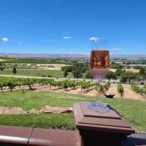 Glass of rosé overlooking vineyards along the Sunnyslope Wine Trail near Caldwell, Idaho.