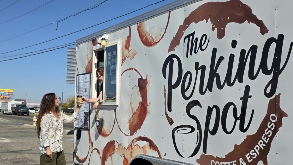 Judit Crace holding coffee in front of The Perking Spot in Nampa