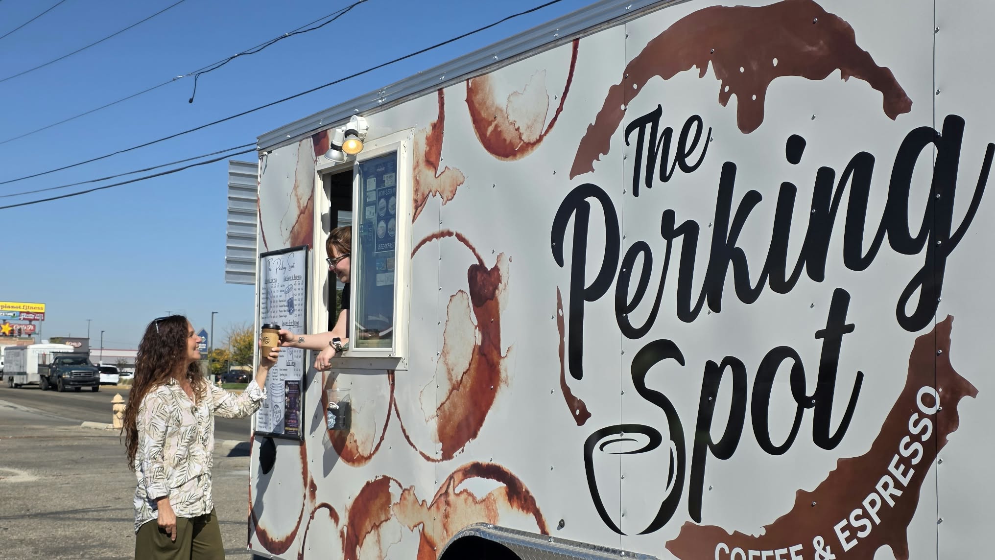 Judit Crace holding coffee in front of The Perking Spot in Nampa