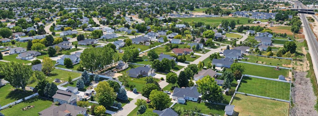 Aerial view of residential homes and large properties illustrating Nampa enclave annexation and surrounding city development.